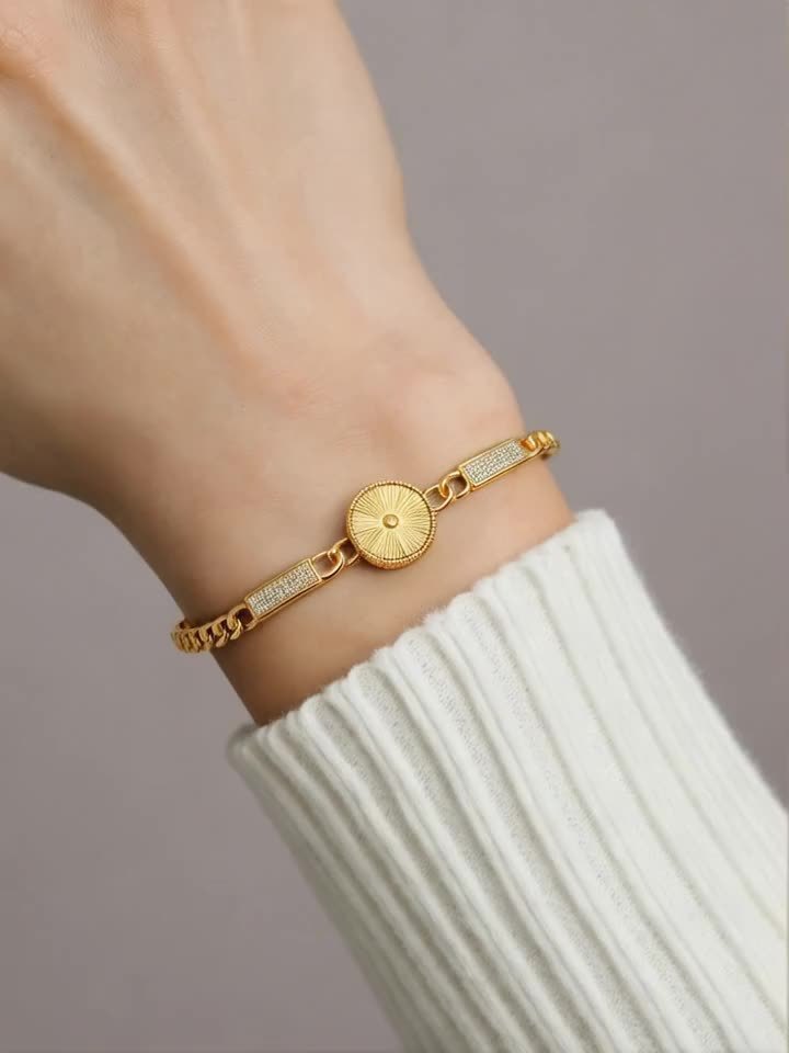 Golden Tone Bracelet with Sunburst Charm & Cubic Zirconia Accents